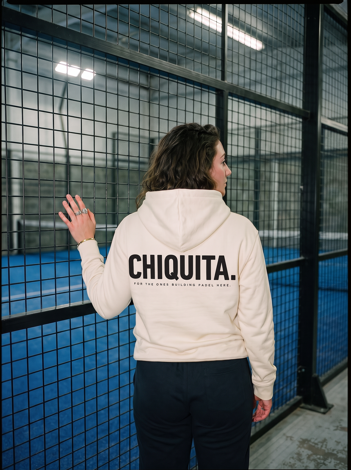 Off White AP Club Chiquita padel hoodie in the court corridor
