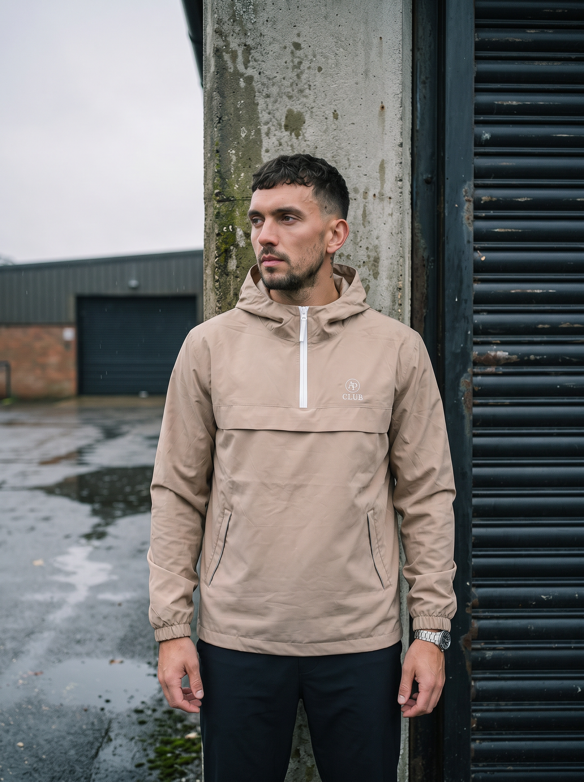 AP Club Shell Jacket in sand photographed in wet British padel conditions
