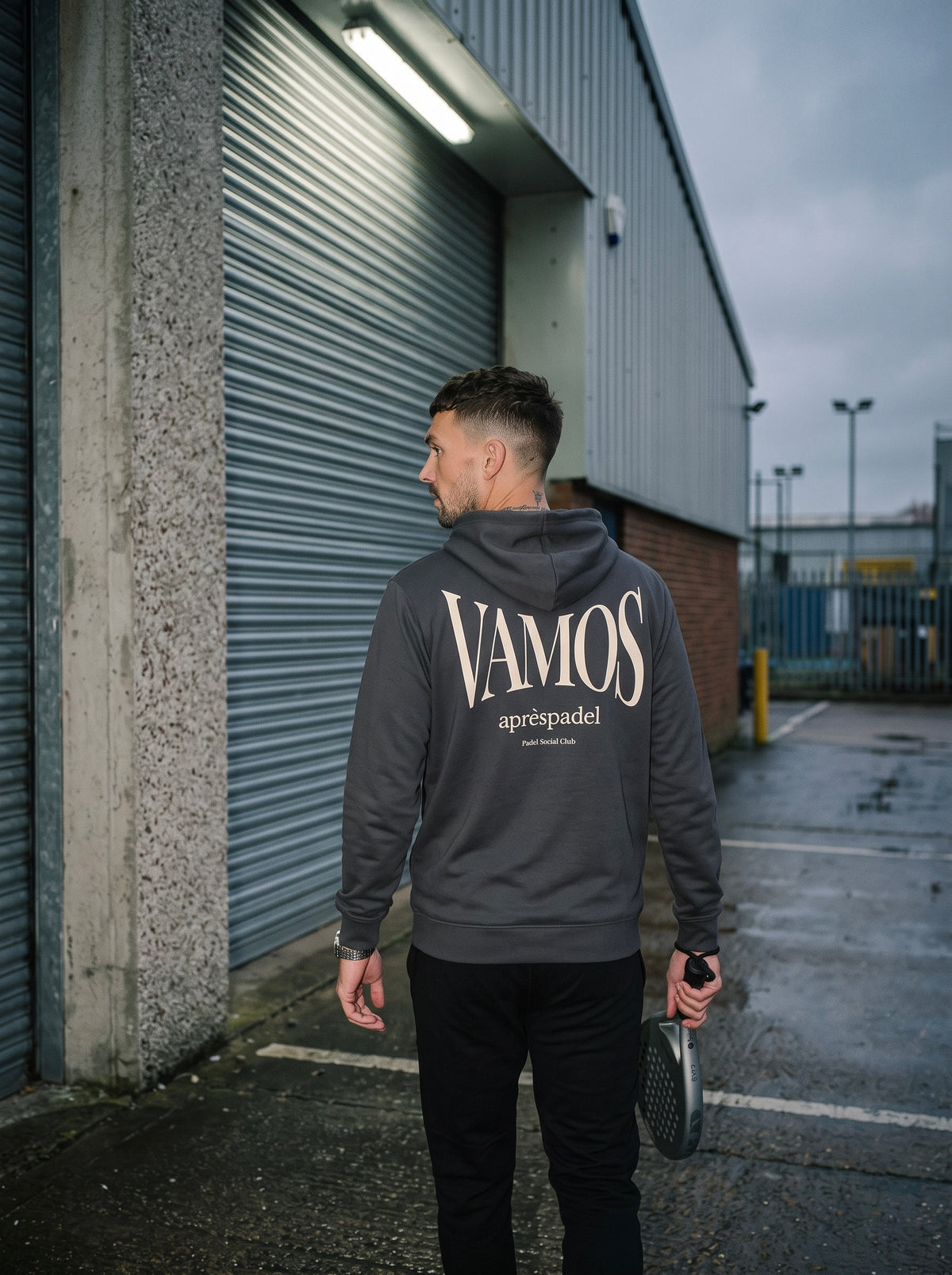 AP Club Vamos Hoodie in charcoal grey at a British padel venue