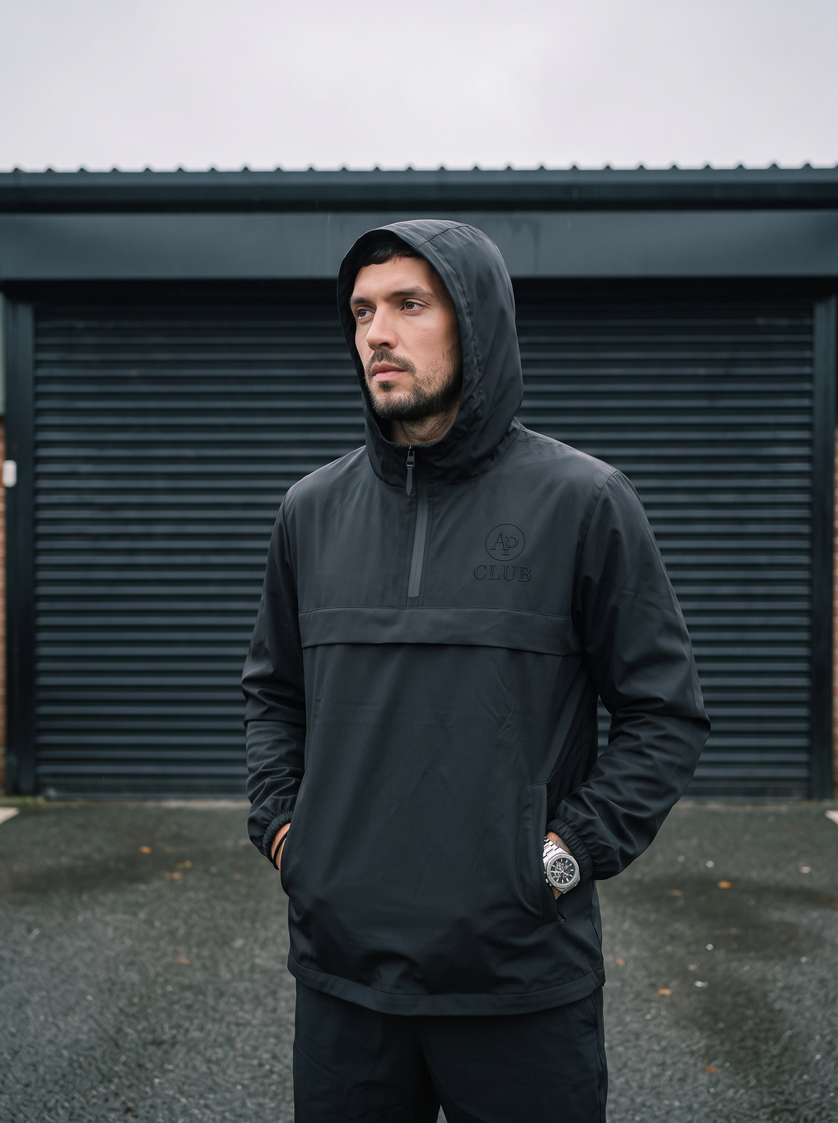 Black AP Club waterproof padel shell jacket in British weather