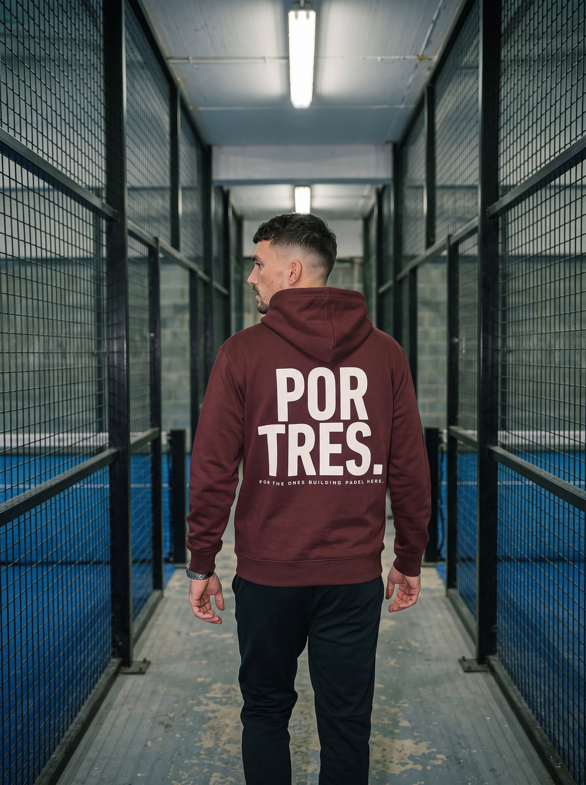 Red Brown AP Club Por Tres padel hoodie in the court corridor