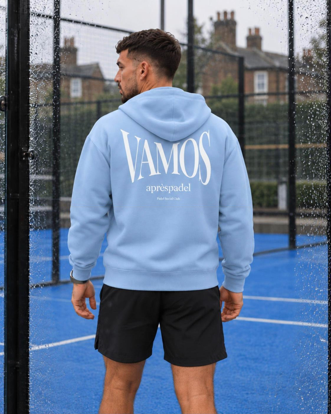 AP Club Vamos Hoodie in Blue Soul with white VAMOS back print on a wet padel court