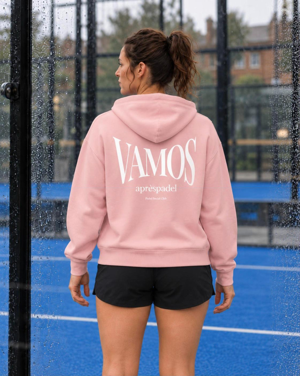 AP Club Vamos Hoodie in Cotton Pink with white VAMOS back print on a wet padel court
